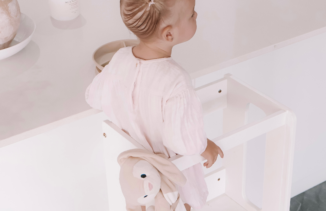 Child standing safely at benchtop in My Happy Helpers Learning Tower