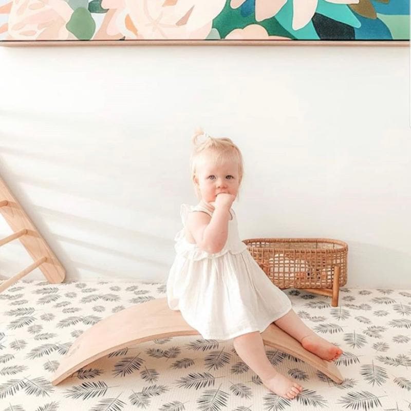 baby sitting on balance board