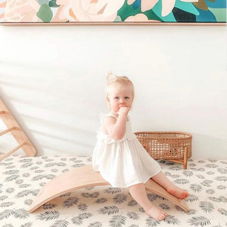 baby sitting on balance board