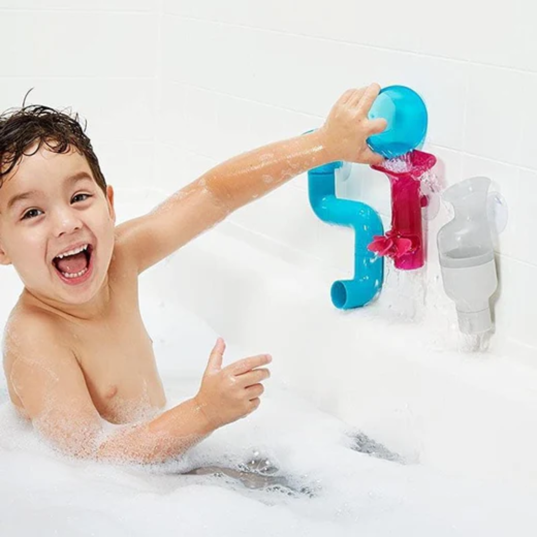 Baby boy playing with bath toys