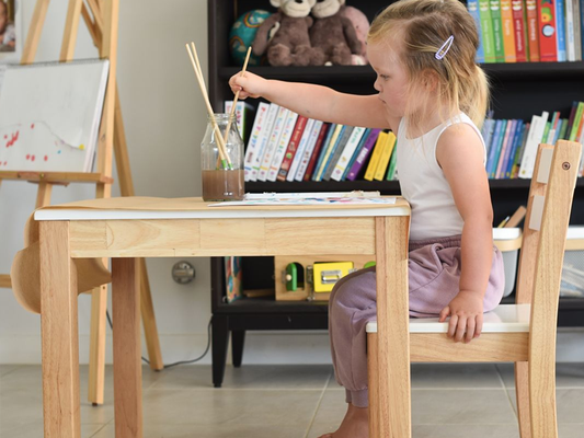 Child painting at table Image Credit: @acraftyliving