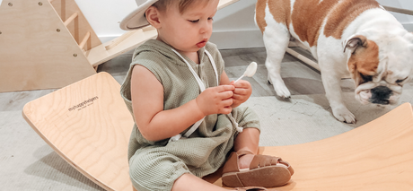 baby boy sitting on balance board
