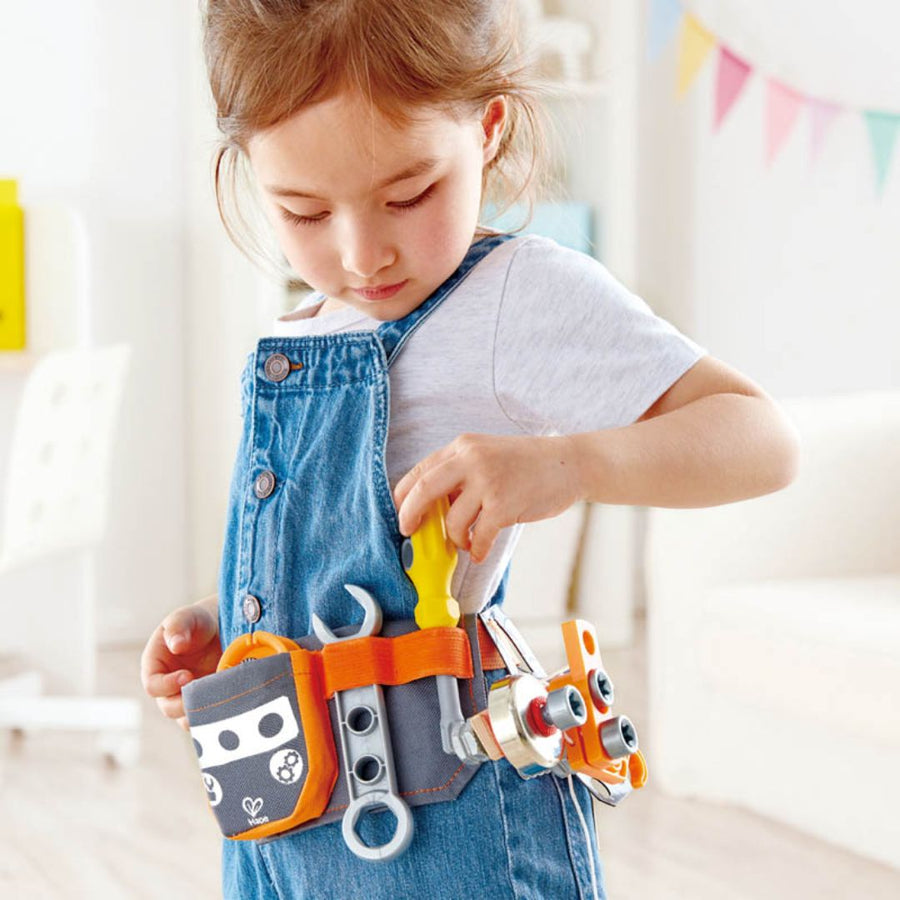 Child playing with kids tool belts at home