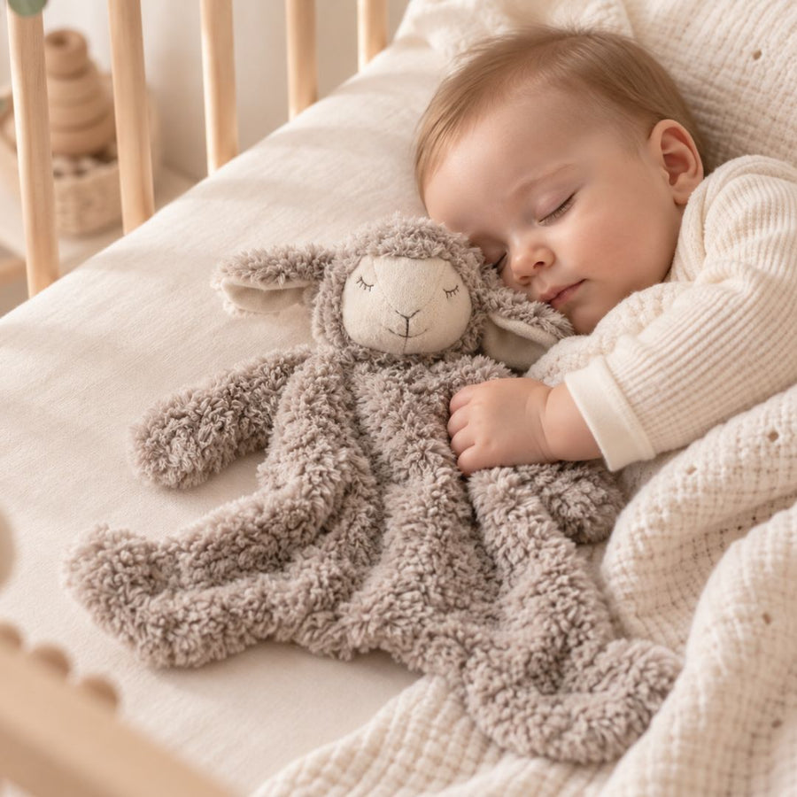 Baby playing with baby comforters