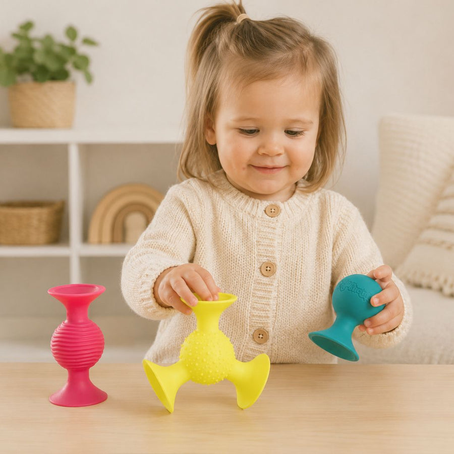 Child playing with fat brain squigz at home
