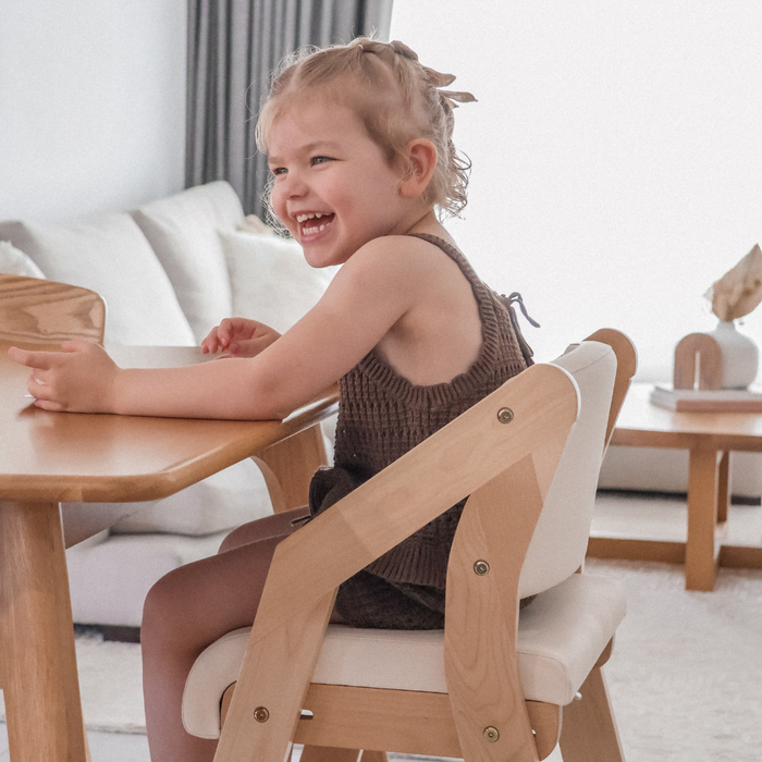young child exploring toddler dining chairs in a calm home playroom setting
