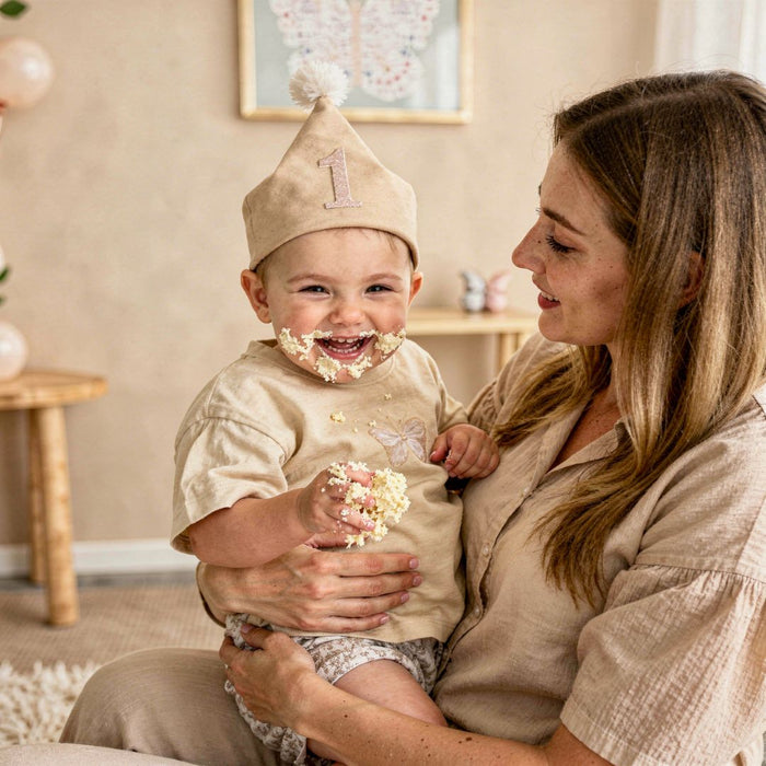 lifestyle image of toddler playing with first birthday gifts in neutral setting