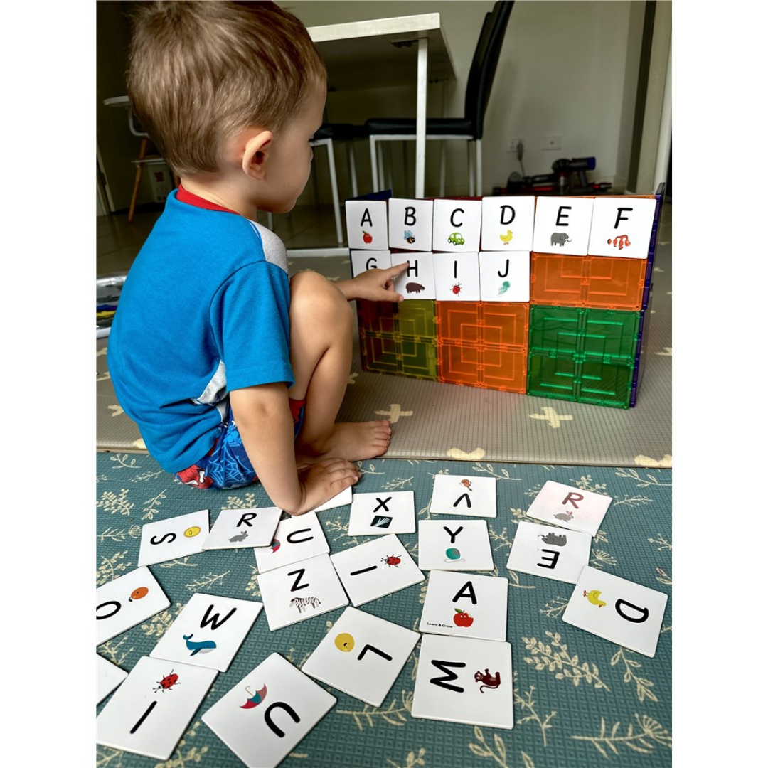 Children playing with the TileTek Alphabet Uppercase Pack Tile Toppers on magnetic tiles