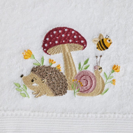 Mushroom Meadow Bath Towel & Face Washer in Organza Bag shown in the hand for scale