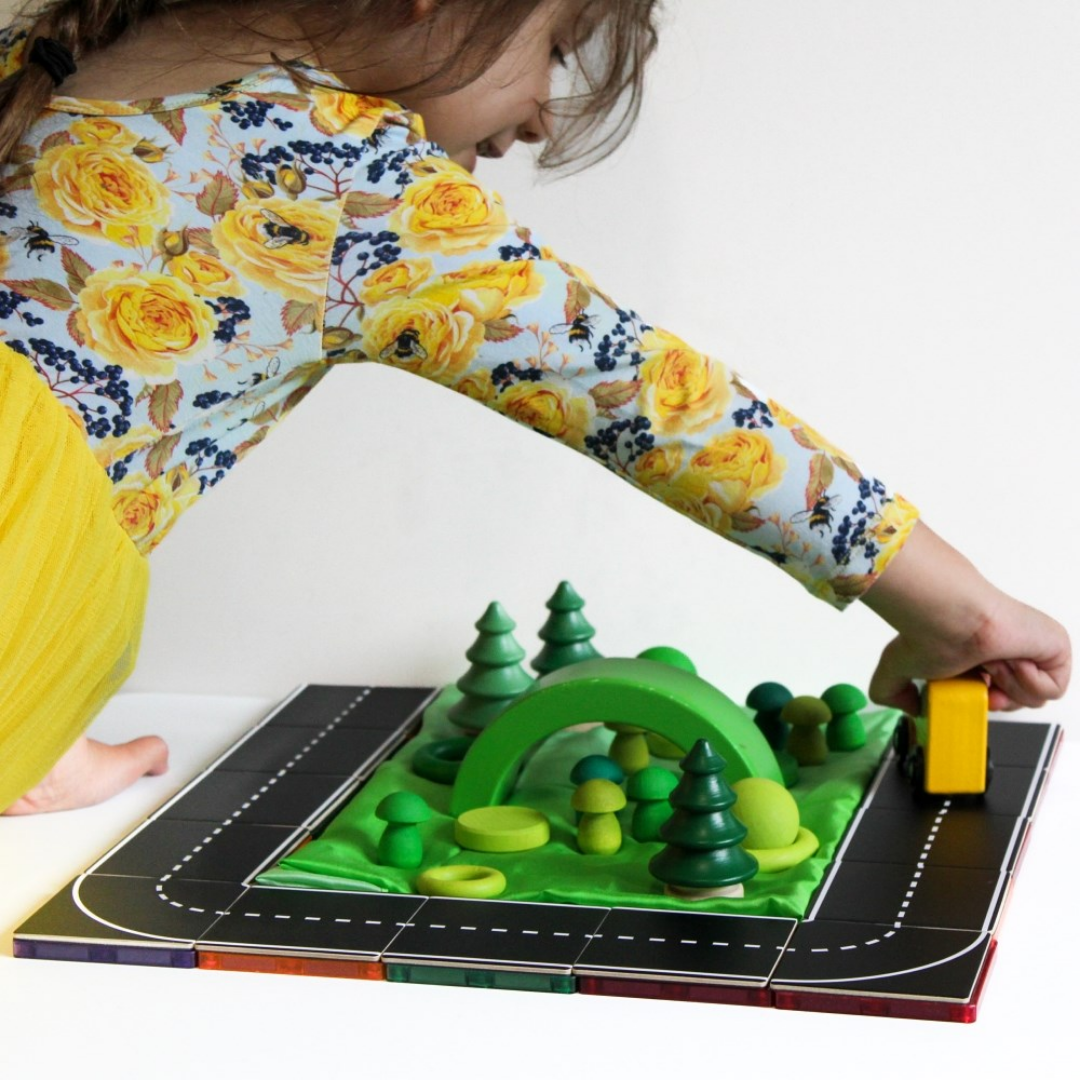 Children playing with the TileTek Road Pack Tile Toppers on magnetic tiles