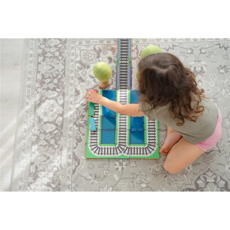 Children playing with the TileTek Train Pack Tile Toppers on magnetic tiles