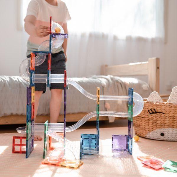 Child building with the Connetix 92 Piece Ball Run