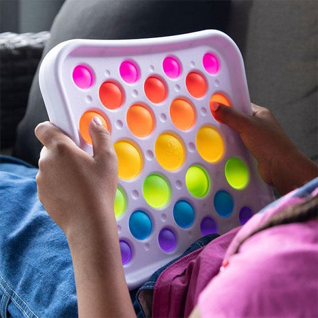 Child playing with the Dimpl Pops Deluxe
