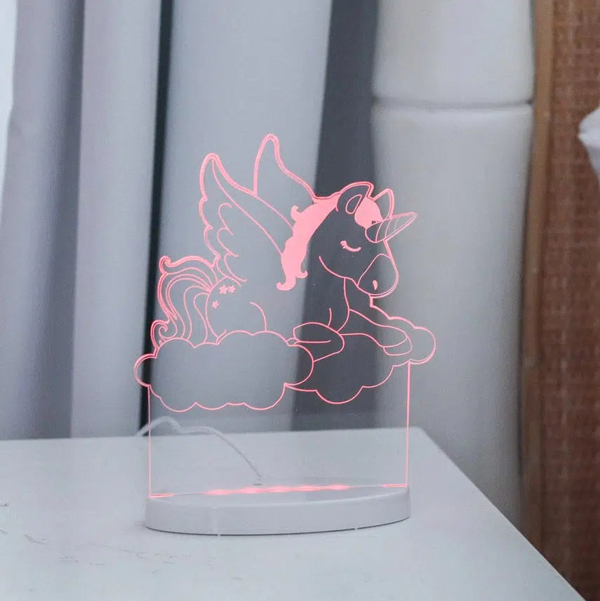 Unicorn night light glowing on a bedside table