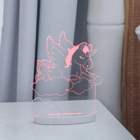 Unicorn night light glowing on a bedside table