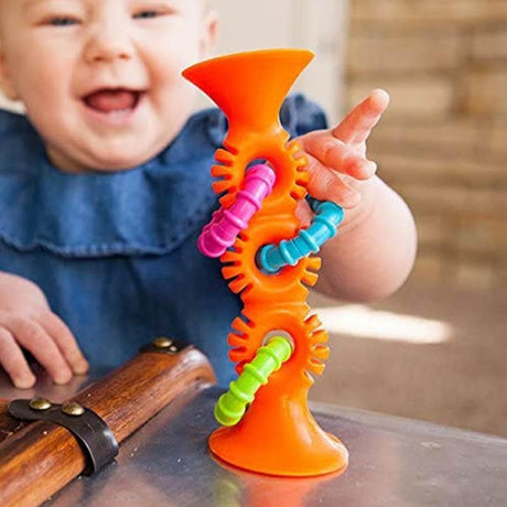 Pip Squigz Loops shown in the hand for scale