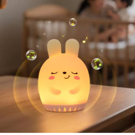 Bunny mini night light glowing beside a cot