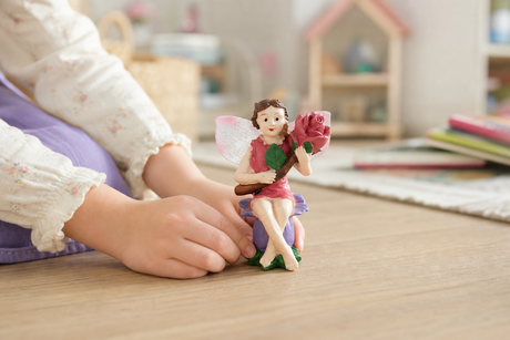 Child playing with the Fairy Holding A Rose