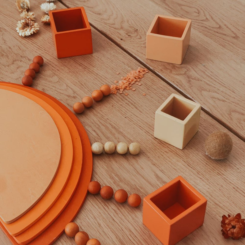 toddler playing with wooden building blocks during open ended play